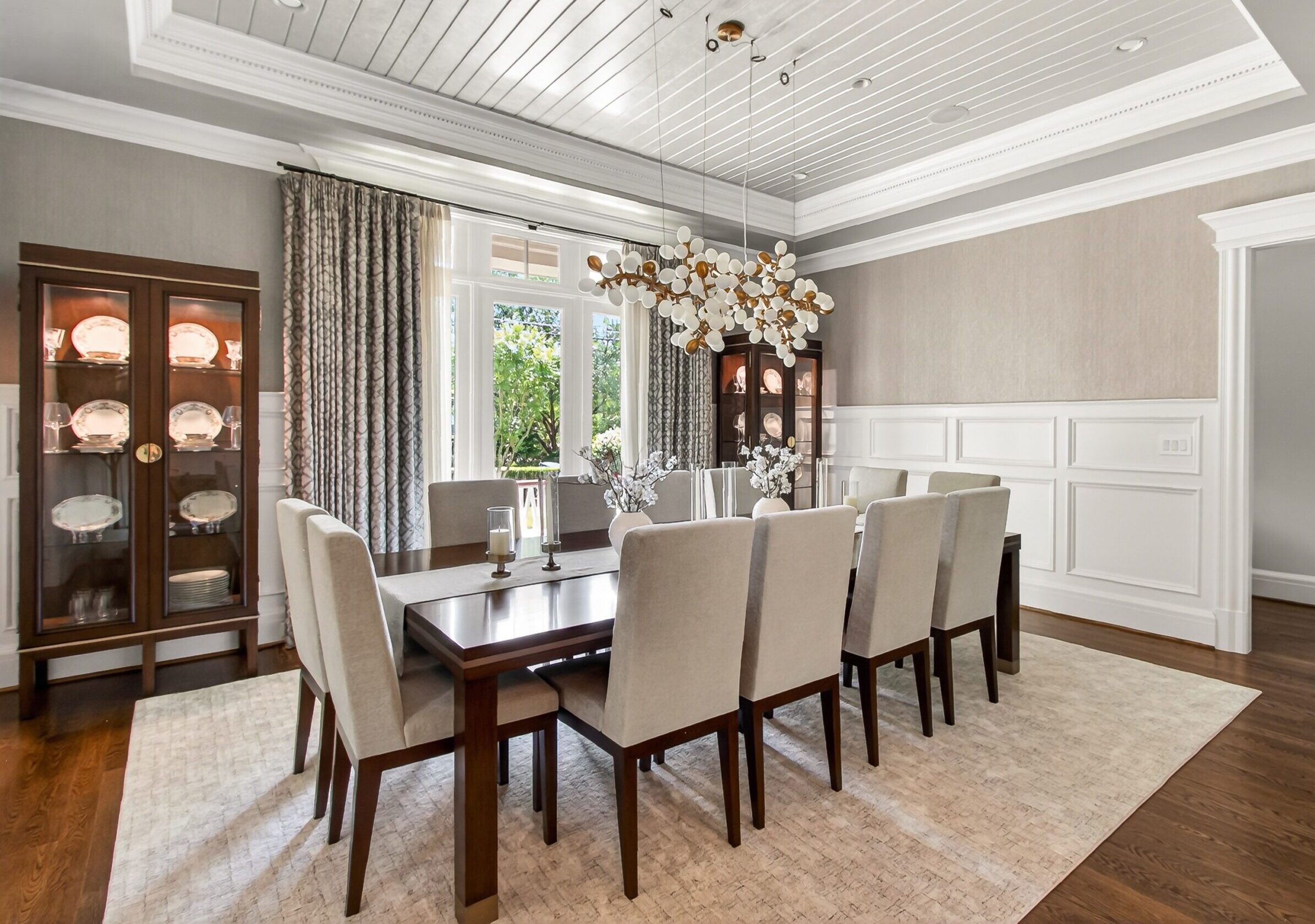 Elegant dining room in McLean, Virginia featuring long dining table and upholstered chairs